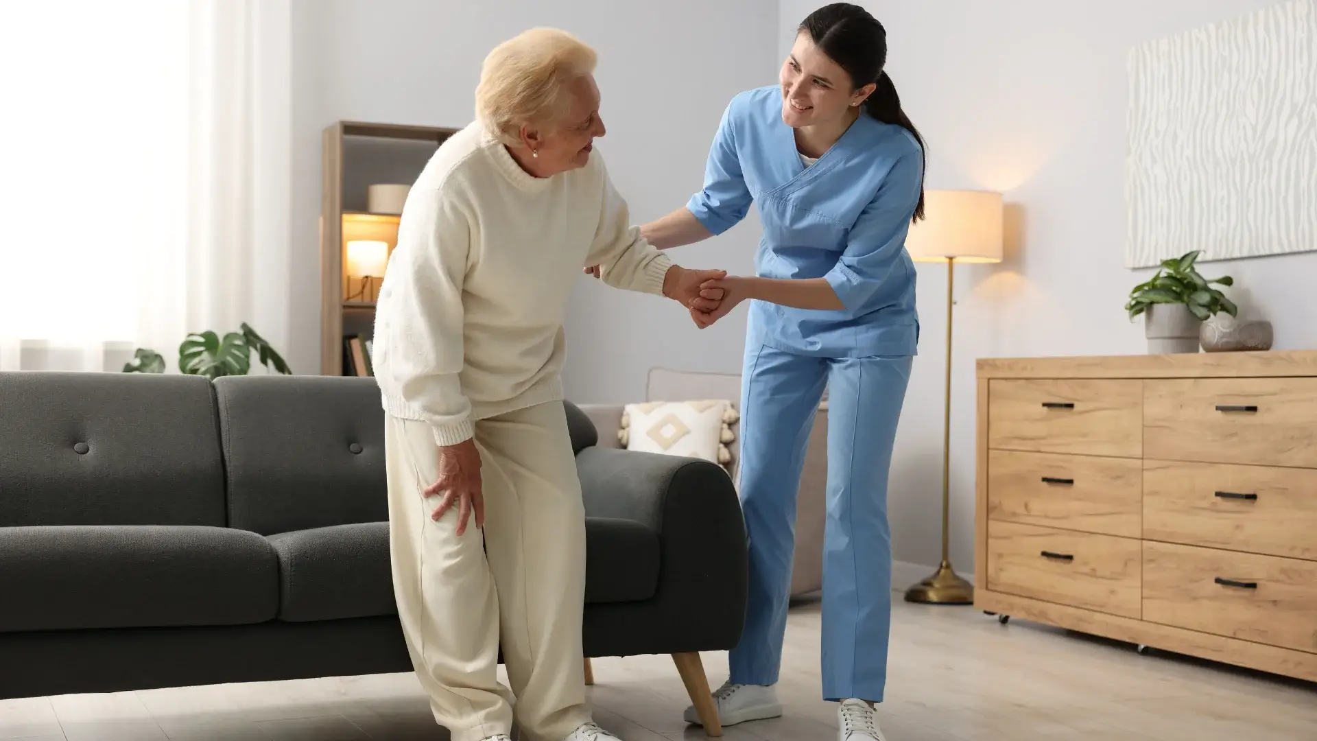 nurse assisting an elderly